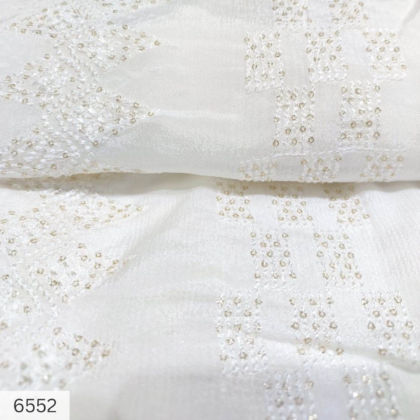 White chinon embroidered fabric in lace pattern